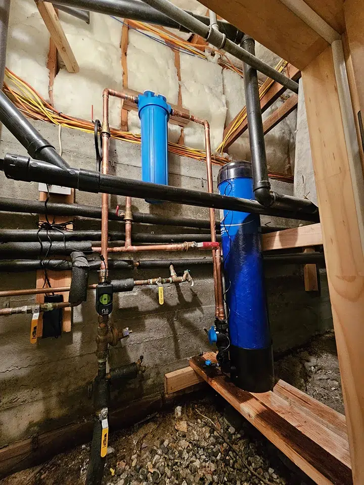 Water filtration setup with sediment filter and carbon tank installed under home in Rancho Cucamonga CA